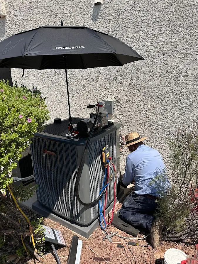 HVAC technician performing outdoor AC maintenance in Van Alstyne